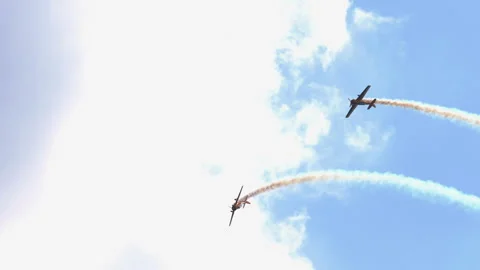 Two aerobatic propeller planes flying with smoke trails at airshow Stock Footage 346664434