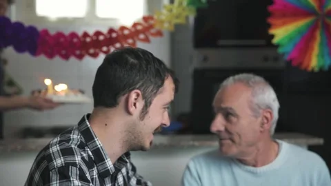 Two affectionate sons celebrate their father's birthday bringing the cake 스톡 동영상 76326855