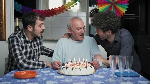 Two affectionate sons celebrate their birthday with their old father Stock Footage 76346376