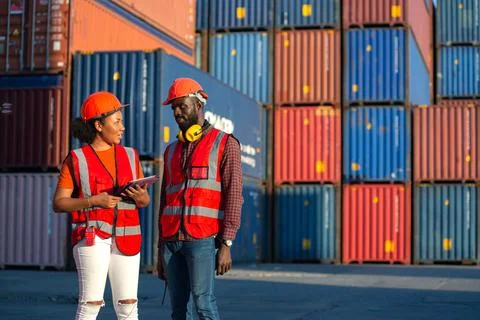 Two African american engineer talking and checking loading Containers box. Stock-Fotos