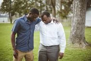 Two African-American Male Friends Standing With Their Hands On The Shoulders  Stock Photos