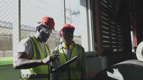 Two African American man using computer tablet checking stock warehouse in Video stock 222062825