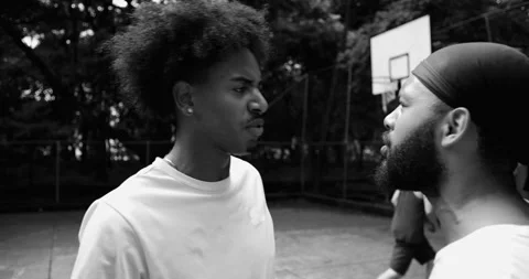 Two African American men angrily confronting each other on basketball court, poi Stock Footage 319833027