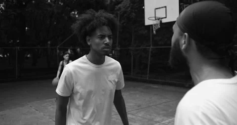 Two African American men in heated argument on outdoor basketball court, shoutin Video stock 319840160
