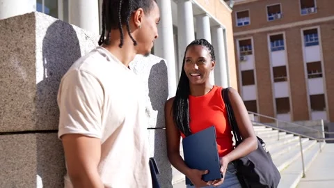 Two african american students talking together on university campus Stock Footage 333753376