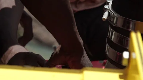 Two African boys working on an engine, detail. Videos about work, africa, motor, Stock Footage 69832005