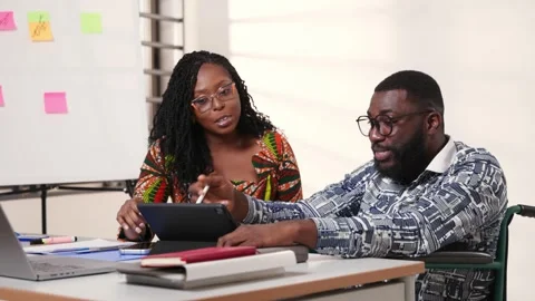 Two African colleagues collaborate on tablet, brainstorming in office Stock Footage 346310971