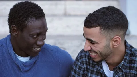 Two African friends from different countries talking and laughing  Stock Footage 218598171