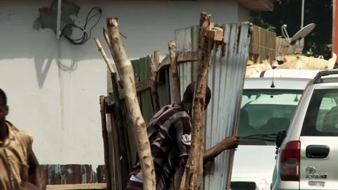 Two African men are fixing a broken fence. Stock Footage 210214406