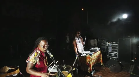 Two african men sing spinning at turntable, play bongo drums on night party. Red Stock Footage 64222642