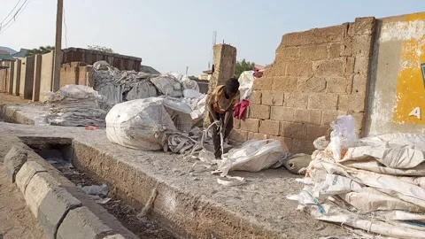Two African Men Sorting Used Sacks By Roadside For Recycling Kano Nigeria Stock Footage 330561679