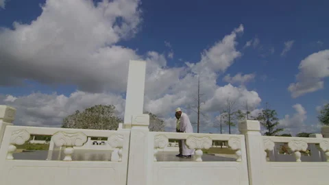 Two African old men lay wreaths at Chinese expert cemetery,   Tanzania  Africa Stock Footage 132431153
