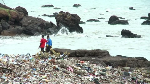 Two African young men walk along the rocky coast of the Atlantic Ocean. There is Stock Footage 154161250