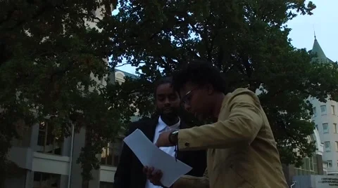Two afro guys discussing documents Stock Footage 68594537