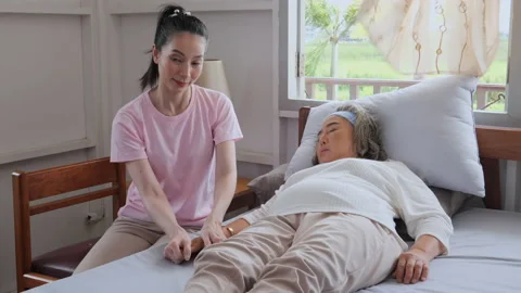 Two age generation are happy on bed at home on vacation. The eldest daughter  Video stock 137879479