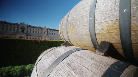 Two aged wine barrels stacked outside in front of historic manor building d.. Stock Footage 339755305