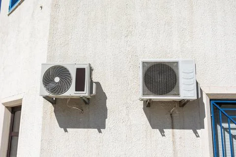 Two air conditioning units on facade. Climate control, summer infrastructure Stock Photos