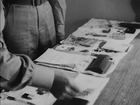 Two Air Interrogation Officers look at the personal belongings (including aƒ Stockbeeldmateriaal 75292340