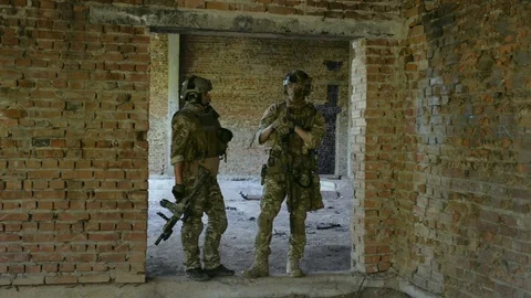 Two air soft man to inspect and speak in urban territory. Stock Footage 127884099