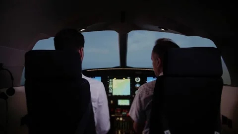 Two airplane pilots preparing for takeoff. Training in flight simulator Stock Footage 208626818