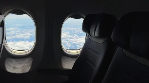 Two Airplane Windows Beside Empty Seat. Low demand for flights and company 스톡 동영상 342898796