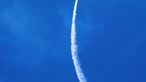 Two airplanes flying on background of blue sky, leaving a condensation trail. 4K Stock Footage 95758098