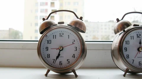 Two alarm clocks on a window sill at morning. Video stock 921537