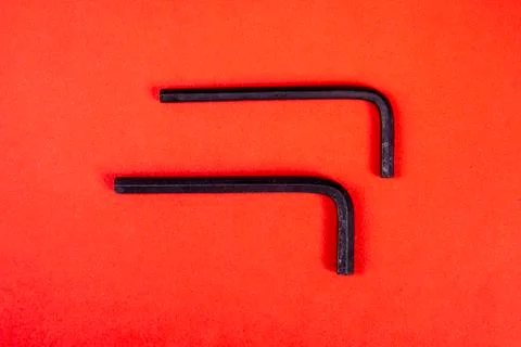 Two Allen keys on red background Stock Photos