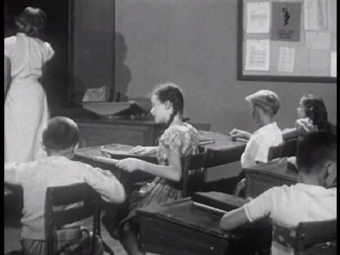 Two American elementary school kids settle their dispute by looking up a word in Video stock 74975284