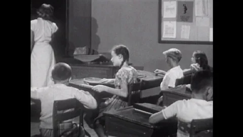 Two American elementary school kids settle their dispute by looking up a word in Video stock 145479319