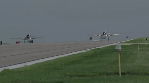 Two American T-6 Texan warbirds taxiing on runway of Wittman Regional Airport Stock Footage 50186523
