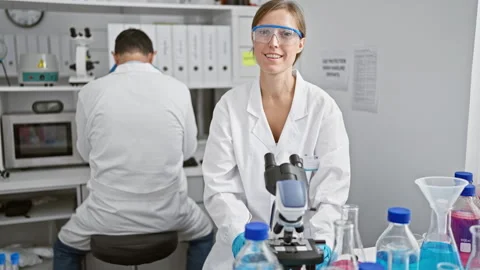 Two amiable scientists, best mates, sitting with arms crossed, engrossed in.. Stock Footage 262770467