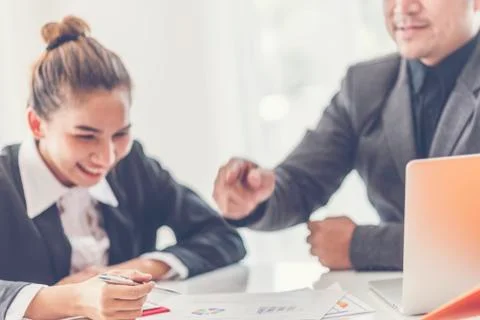 Two analysts discussing online data in front of laptop Stock Photos