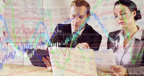 Two analysts reviewing laptop reports, data sparking charts marking numbers Stockbeeldmateriaal 328417831