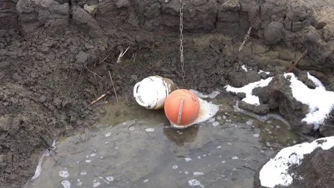 Two anchor floats on the bottom of Lake Domaa during a water shortage Stock Footage 303249264