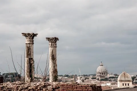 Two ancient columns standing on the top of the wall with ancient Romanian cat Stock Photos