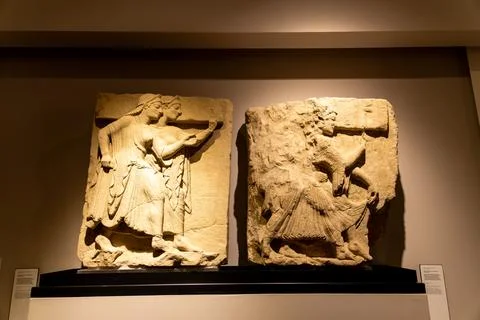 Two ancient reliefs with human figures on display Photos