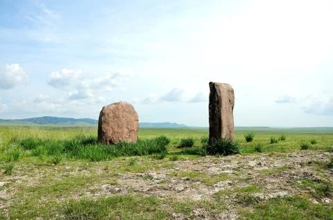 Two ancient sacral stones set in the endless steppe. Stock Photos