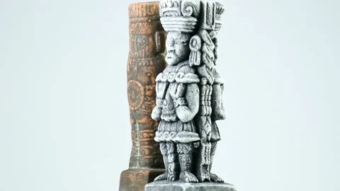 Two ancient sculptures rotating on rotating plate Stock Footage 167599324