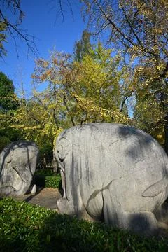 Two ancient stone elephants under blue sky in sunny afternoon Stock Photos