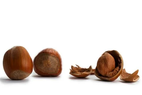 Two and a cracked hazelnut Stock Photos
