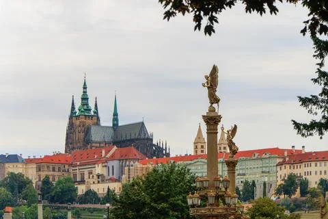 Two angels standing on columns of the bridge over the Vltava river in Prague. Stock Photos