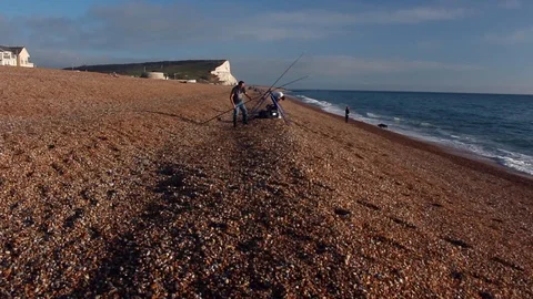 Two angler are angling at Seaford UK  before a strong storm Stock Footage 102485510