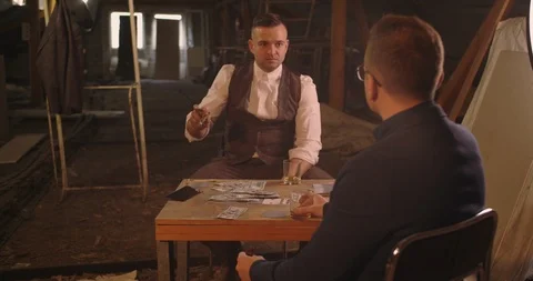 Two angry handsome elegant men talking each other for playing illegal cards game Stock Footage 117670449