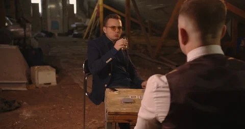 Two angry handsome elegant men talking each other for playing illegal cards game Stock Footage 117671481