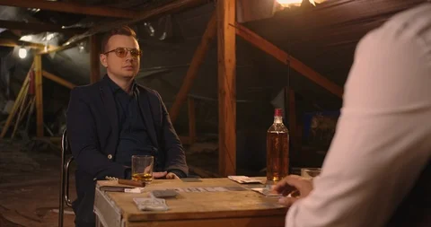 Two angry handsome elegant men talking each other for playing illegal cards game Stock Footage 117673171