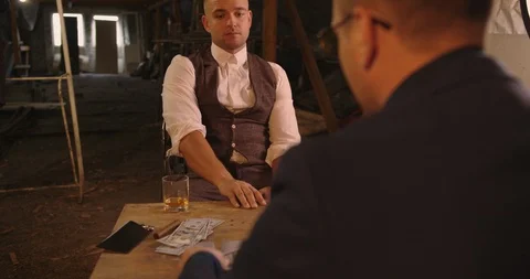 Two angry handsome elegant men talking each other for playing illegal cards game Stock Footage 117673982