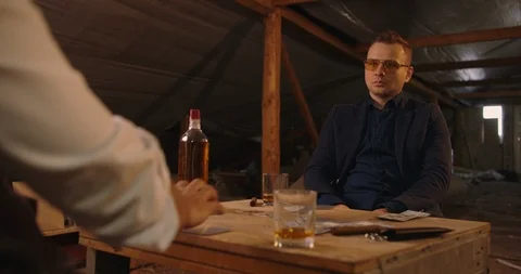 Two angry handsome elegant men talking each other for playing illegal cards game Stock Footage 117675494