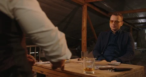 Two angry handsome elegant men talking each other for playing illegal cards game Stock Footage 117676319