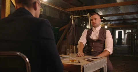 Two angry handsome elegant men talking each other for playing illegal cards game Stock Footage 117677810